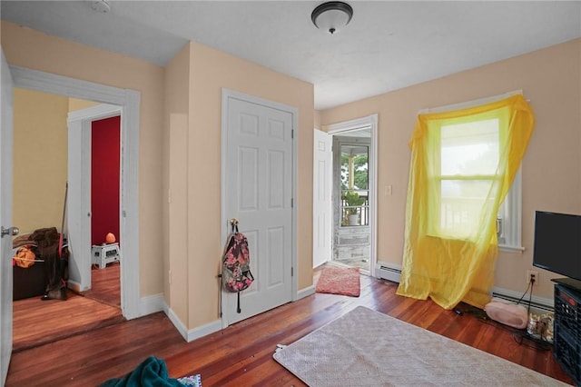 entrance foyer with baseboard heating and dark wood-type flooring