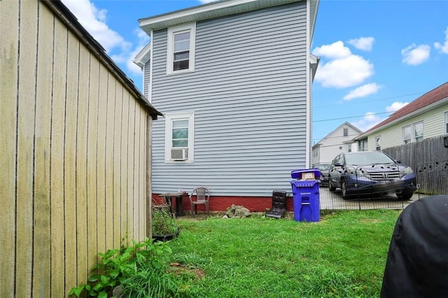 view of side of property with a yard