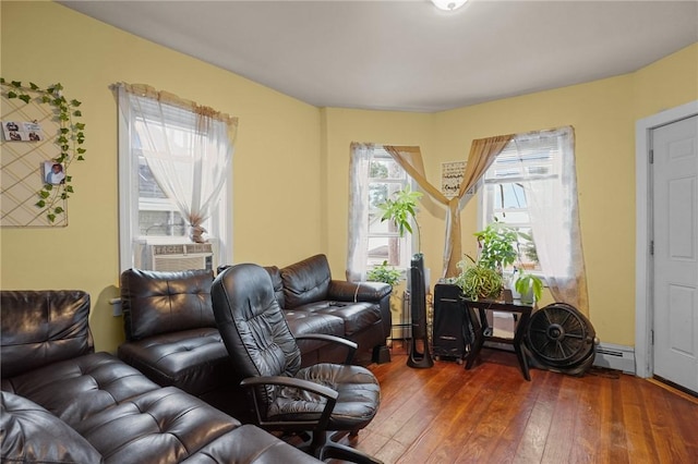 living room with a wealth of natural light, cooling unit, baseboard heating, and dark wood-type flooring