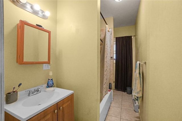 bathroom with tile patterned flooring, vanity, and shower / bathtub combination with curtain