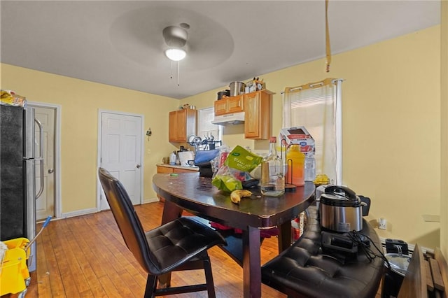 dining space featuring light hardwood / wood-style flooring and ceiling fan