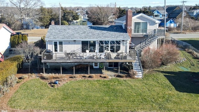 rear view of property with stairs, a lawn, a chimney, and a wooden deck