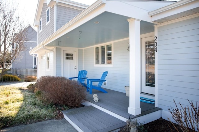 view of exterior entry featuring covered porch