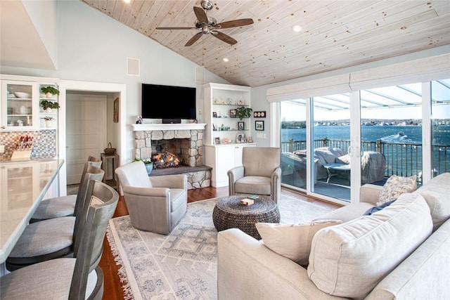 living room with a fireplace, wood finished floors, visible vents, a sunroom, and wood ceiling