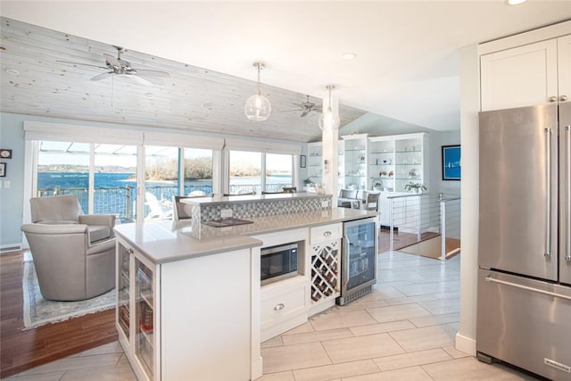 kitchen featuring stainless steel appliances, wine cooler, white cabinets, and ceiling fan