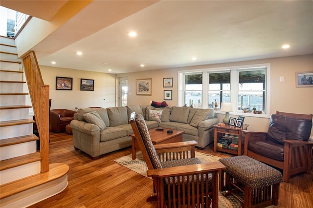 living area featuring stairway, a skylight, wood finished floors, and recessed lighting