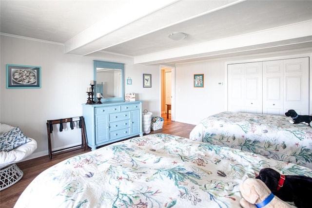 bedroom featuring a closet, crown molding, and wood finished floors