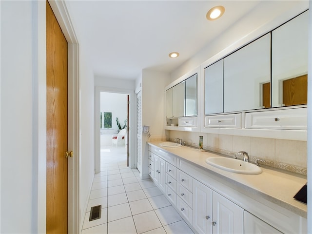 bathroom featuring tile patterned floors, decorative backsplash, and vanity