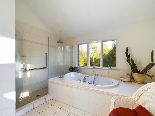 bathroom featuring shower with separate bathtub, tile patterned floors, and lofted ceiling