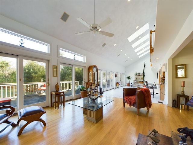 living room with ceiling fan, light hardwood / wood-style floors, high vaulted ceiling, and french doors