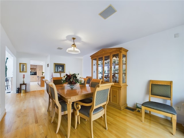 dining room with light hardwood / wood-style floors