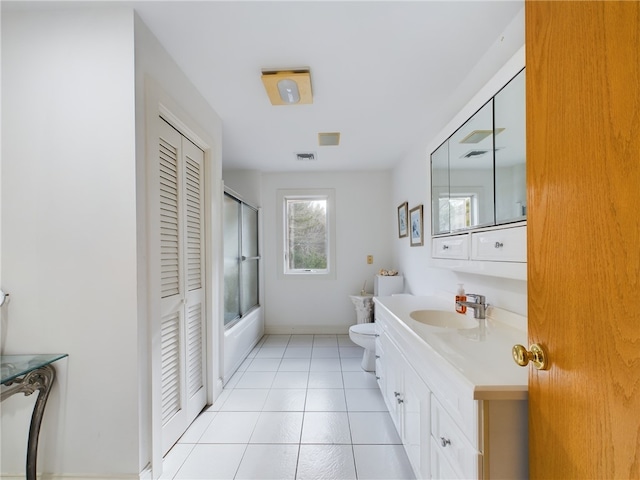 full bathroom featuring tile patterned flooring, vanity, toilet, and enclosed tub / shower combo