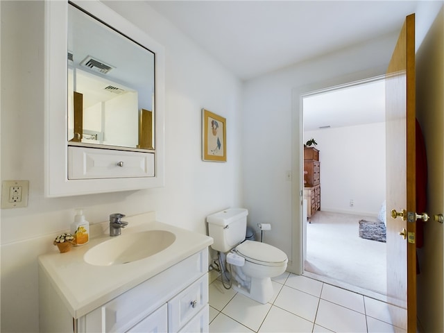 bathroom featuring tile patterned floors, vanity, and toilet