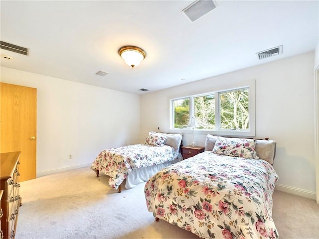 bedroom with light colored carpet