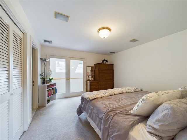 bedroom featuring access to outside, a closet, french doors, and light carpet