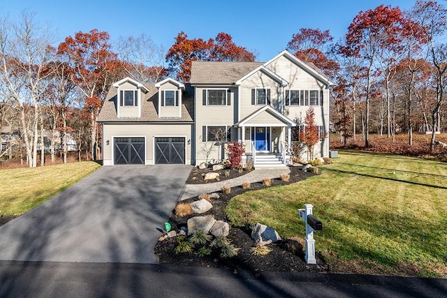 view of front of property featuring a garage and a front lawn