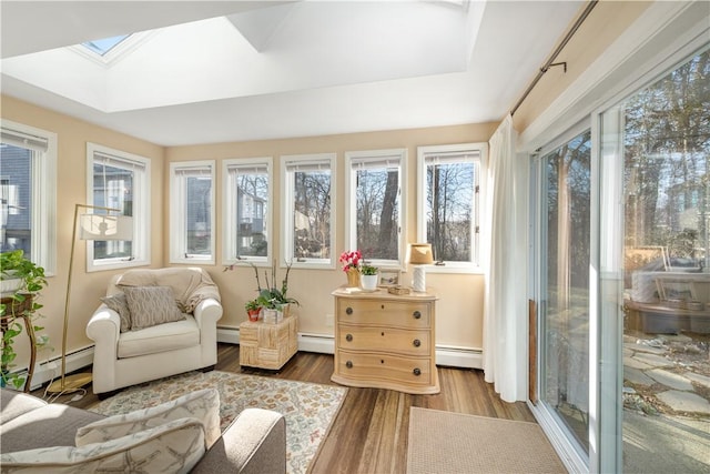 sunroom with a baseboard heating unit and a skylight