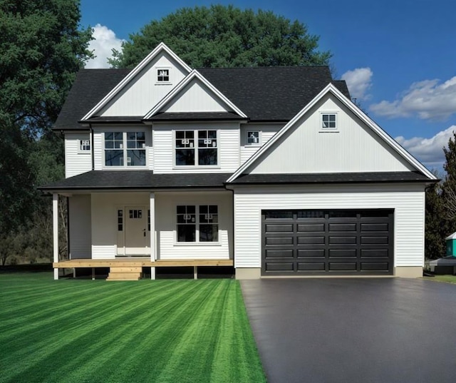 view of front of home with driveway, a garage, a shingled roof, covered porch, and a front yard