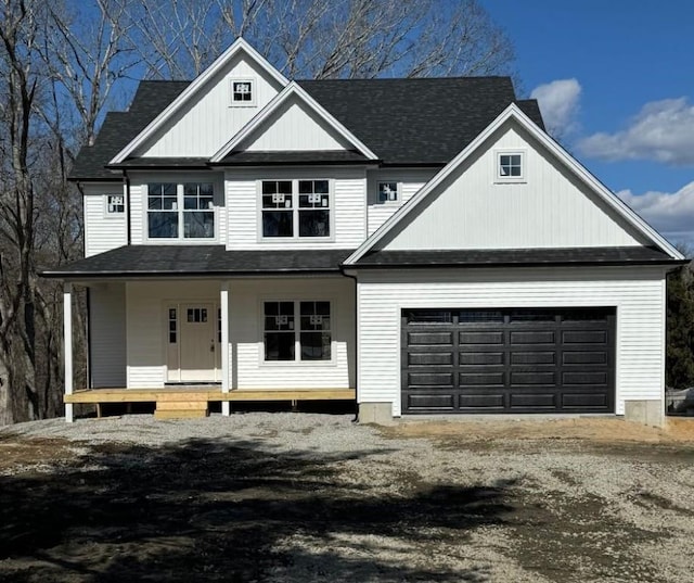 view of front of house with covered porch, driveway, and a garage