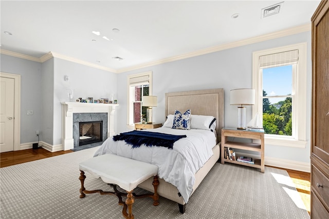 bedroom with hardwood / wood-style floors and ornamental molding