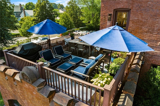 deck with a grill and exterior kitchen