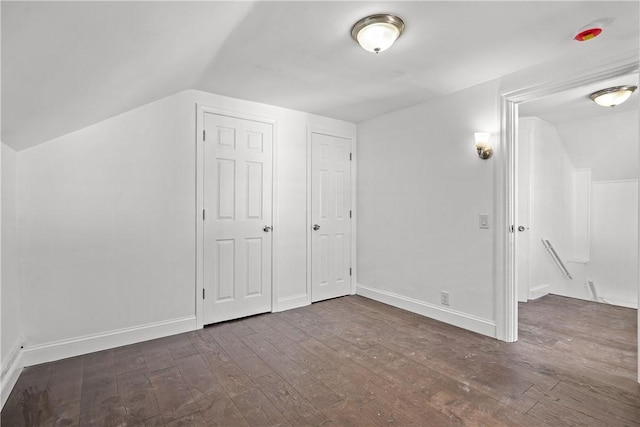 bonus room featuring dark hardwood / wood-style flooring and lofted ceiling