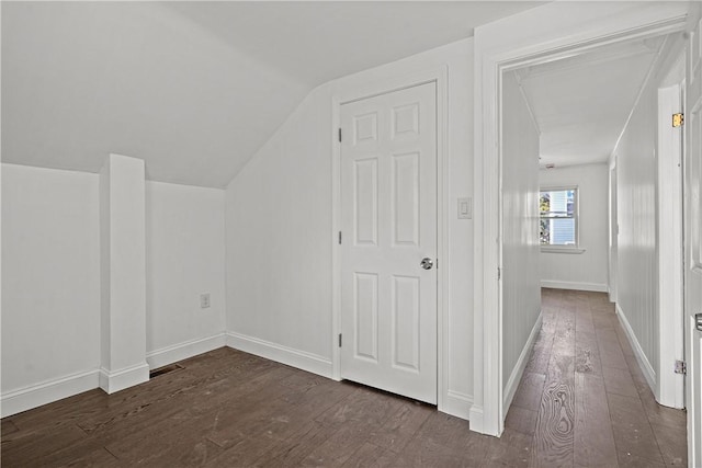 bonus room with lofted ceiling and dark wood-type flooring