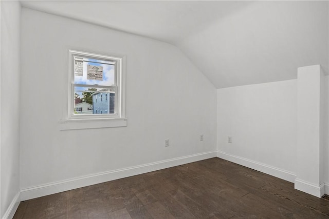 additional living space featuring dark hardwood / wood-style flooring and vaulted ceiling