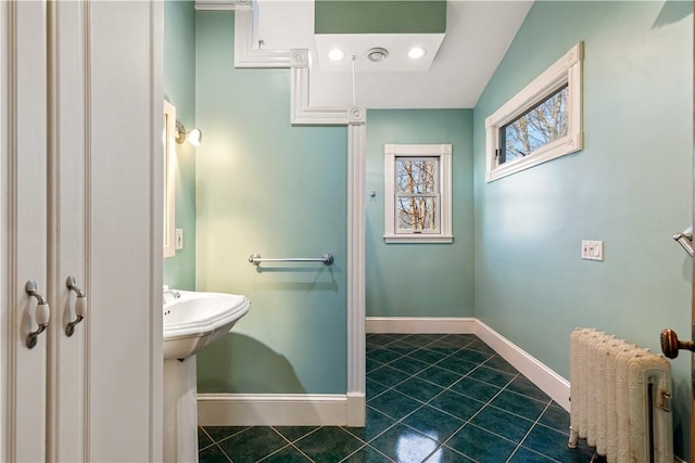 bathroom featuring tile patterned floors, radiator heating unit, and lofted ceiling