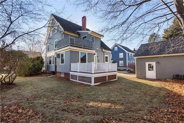 back of property featuring a lawn and a balcony