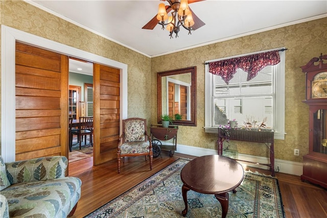 living area featuring hardwood / wood-style flooring and crown molding