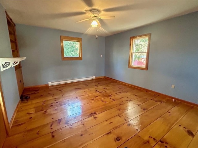 unfurnished room featuring ceiling fan, a baseboard radiator, and wood-type flooring