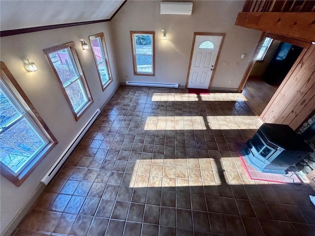 foyer entrance featuring baseboard heating, a healthy amount of sunlight, and lofted ceiling