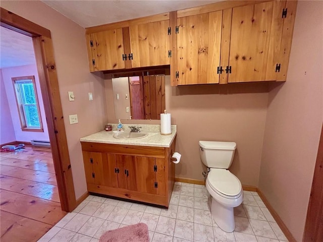 bathroom featuring vanity, a baseboard radiator, and toilet