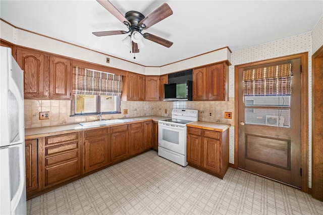 kitchen with ceiling fan, sink, and white appliances