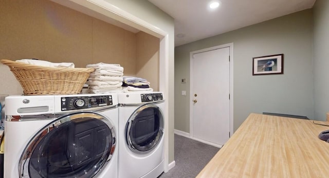 laundry area with washing machine and clothes dryer and dark carpet