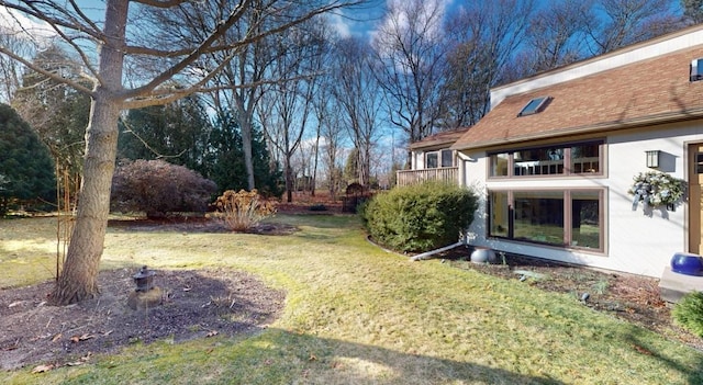 view of yard with a balcony