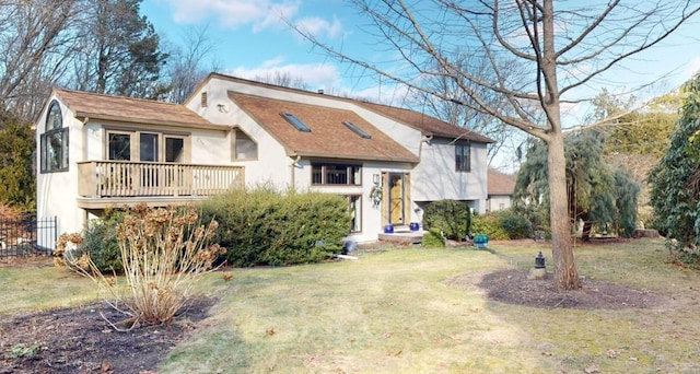 view of front of home featuring a deck and a front lawn