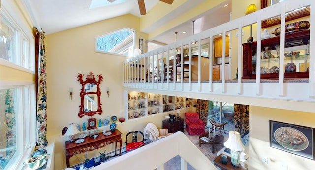 interior details with ceiling fan and a skylight