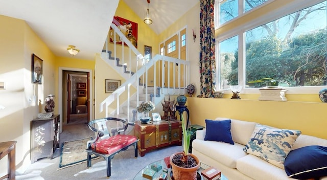 living room featuring light colored carpet and vaulted ceiling