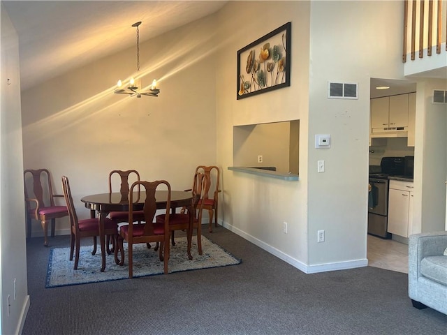 dining space featuring dark carpet and an inviting chandelier