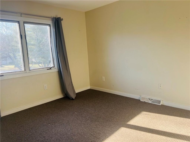 carpeted empty room featuring plenty of natural light