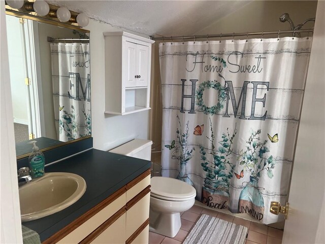 bathroom featuring tile patterned flooring, vanity, and toilet