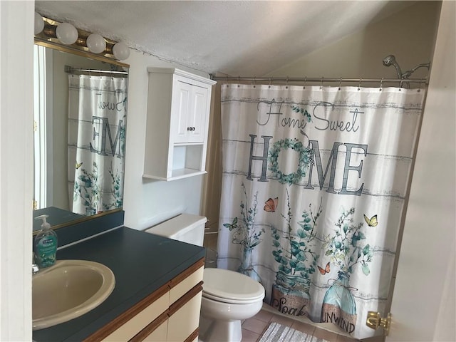 bathroom with tile patterned flooring, vanity, and toilet