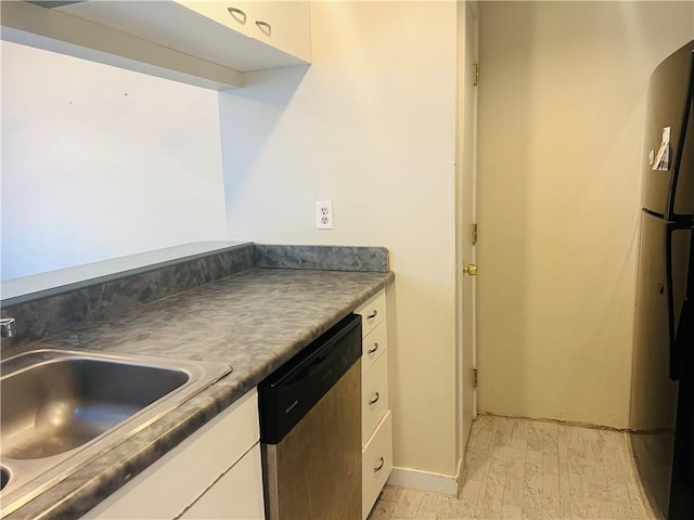 kitchen with white cabinetry, sink, light hardwood / wood-style floors, and appliances with stainless steel finishes