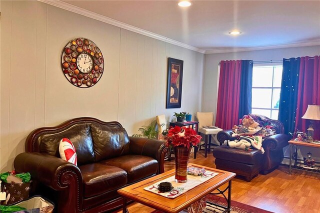 living room with hardwood / wood-style floors and crown molding