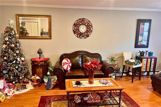 living area with crown molding and wood finished floors