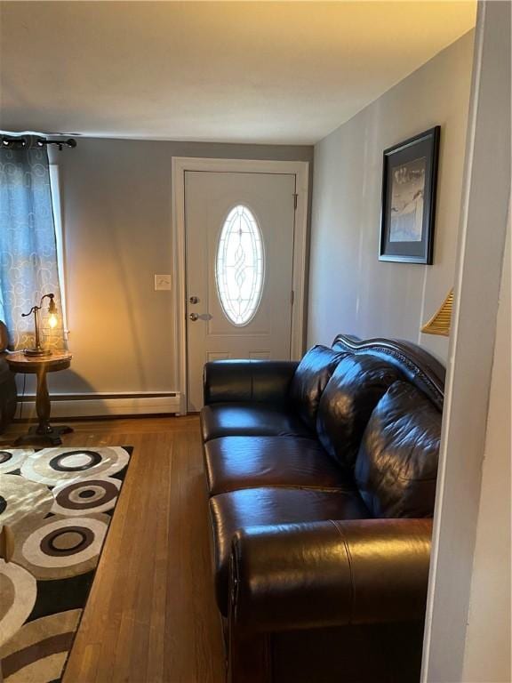 living area with baseboard heating and wood-type flooring