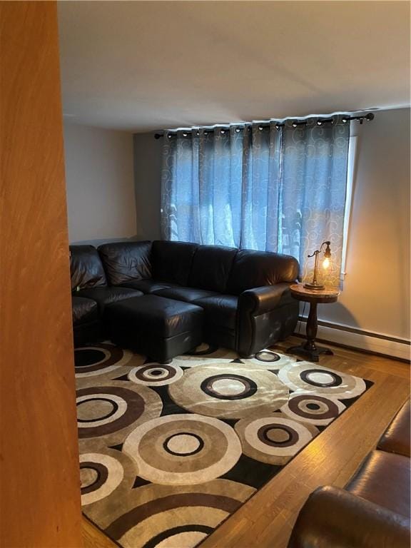 living room featuring baseboard heating and wood finished floors