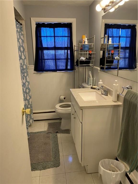 full bathroom with a baseboard radiator, toilet, tile patterned floors, vanity, and a shower with curtain